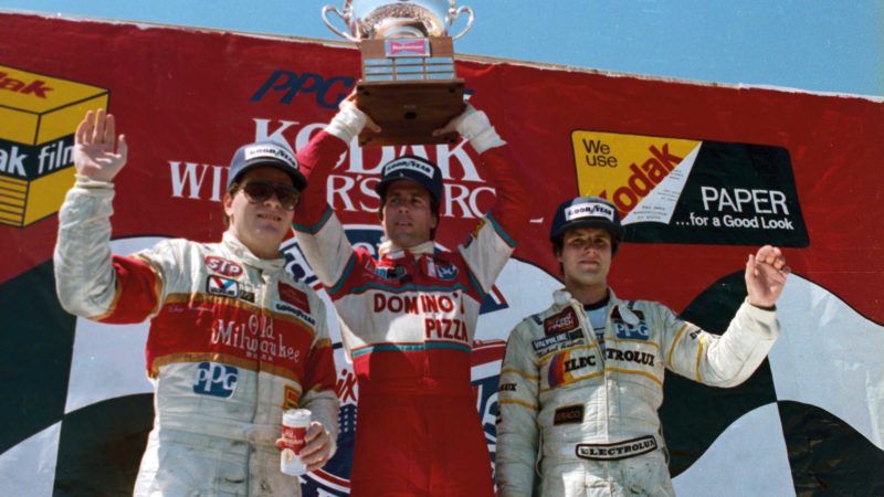 Ganassi celebrating with Danny Sullivan and Michael Andretti